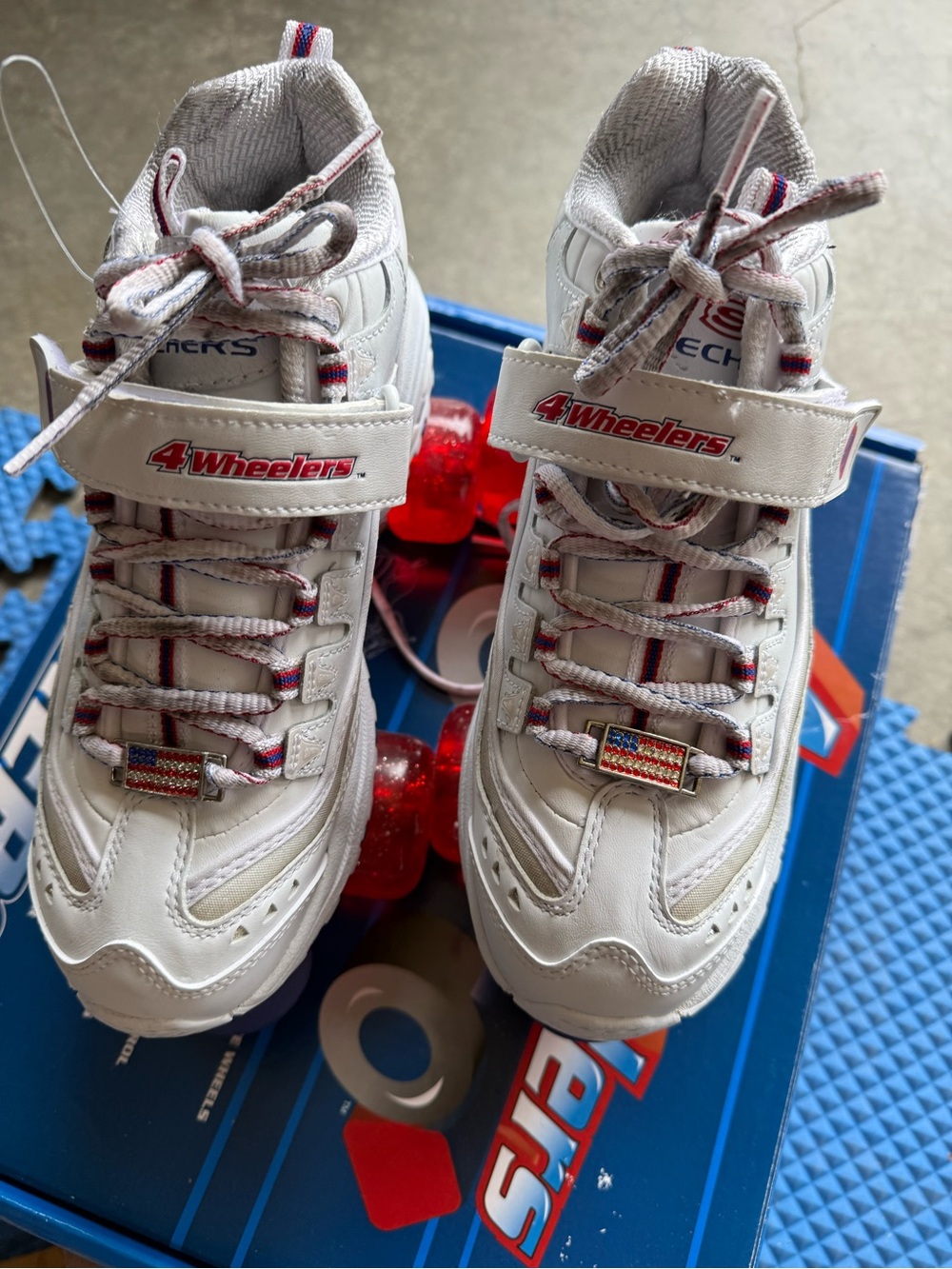 Skechers White Womens 4Wheelers Sneakers with Red Wheels and Flag Accents